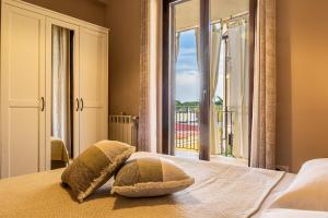 a bedroom with a bed with a large window at Villetta Desiderio Apartment in Giardini Naxos