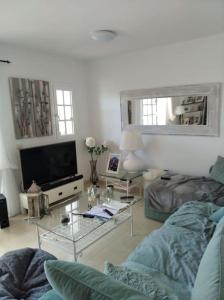 a living room with a couch and a glass table at Maison en duplex & rooftop in Callao Salvaje