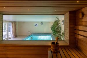 a swimming pool seen through a window in a house at Villa Muusa with a cozy sauna, swimming pool and large beautiful garden in Tallinn