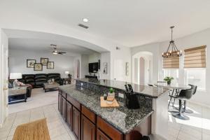 a kitchen with a counter top and a living room at Elegant Mediterranean Hotel Style Home W Hot Tub in Sacramento