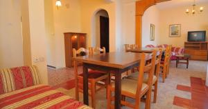 a dining room with a wooden table and chairs at Pansion panorama family apartment in Skala Marion
