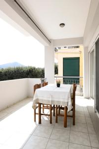 a dining room with a table and chairs and a chalkboard at Villa Bolero in Iraklitsa