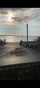 a bench in a parking lot next to the ocean at The Captains Wheel in Skerries