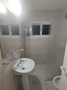 a bathroom with a sink and a shower at La Casa de Belén in Villa General Belgrano