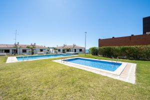 a swimming pool in the yard of a house at Hauzify I Casa Mirador in L'Ametlla de Mar