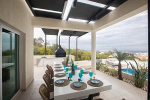 a dining room with a table and a view of the ocean at Romeo & Juliet in Protaras
