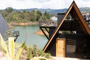 a house with a view of a lake at GRETEL CHALETS SUIZO in Guatapé