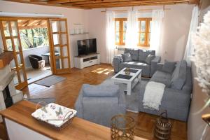 a living room with a couch and a tv at Villa Ella Tvrdos in Trebinje