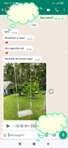 a screenshot of a text message with a swing in a park at Casa confortável em local tranquilo. in Rodeio