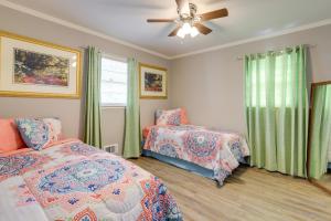 a bedroom with two beds and a ceiling fan at Cozy and Convenient Macon Home about 3 Mi to Town! in Macon