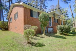 a brick house with a tree in the yard at Cozy and Convenient Macon Home about 3 Mi to Town! in Macon