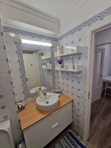 a bathroom with a sink and a mirror at Amazing Terrace Costa da Caparica in Costa da Caparica +38 photos
