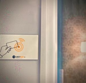 a sign on a wall with a hand holding a light at B&B Le Mansarde in Pescara