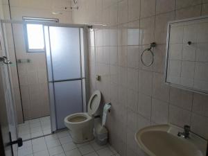 a bathroom with a shower and a toilet and a sink at Bela Vista Praia Grande in Solemar