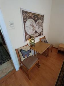 a dining room with a table and a butterfly painting at Lviv Rest Zelena in Lviv