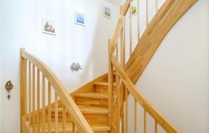 a wooden staircase in a home with white walls at Lovely Home In Büsum Nordsee Ressort in Büsum +21 photos