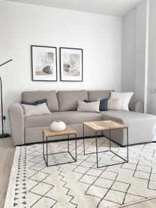 a living room with a couch and two tables at Smart Stay Córdoba in Córdoba