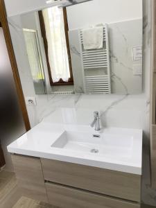 a bathroom with a white sink and a mirror at Lennolake Relax House in Lenno
