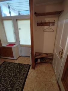 a hallway with two windows and a door with a rug at Lviv Rest Zelena in Lviv +5 photos