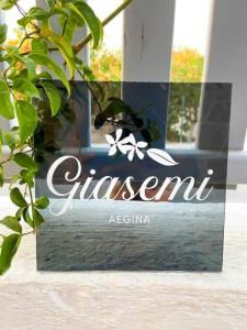 a sign for a restaurant on a glass door at Giasemi Aegina, Modern House in Áyioi Asómatoi