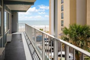 a balcony of a condo with a view of the beach at Blu Atlantic Hotel & Suites in Myrtle Beach