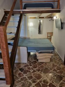 a small room with a bunk bed and stairs at Casa vacanze Piazza San Pietro in Bari