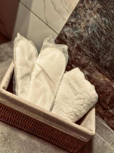 a basket filled with folded towels in a bathroom at HESTİA ILICA in Cesme