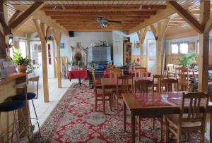 a dining room with wooden tables and chairs at Hostel Mansikka in Taipalsaari