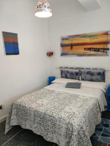 um quarto com uma cama e um quadro na parede em La casa di Zahra em Riccò del Golfo di Spezia