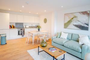 a living room with a blue couch and a table at 39 Teesra House in Plymouth