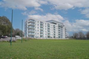 a large white building with a field in front of it at 39 Teesra House in Plymouth