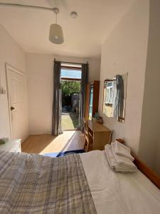 a bedroom with a bed and a door to a yard at Homestay near Tottenham Hotspur Stadium in London