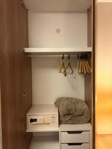 a walk in closet with a microwave and a box at Rio Stay Residence in Rio de Janeiro