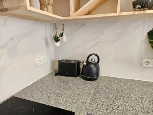 a tea kettle sitting on the floor of a room at Curtido House Suits in Ílhavo