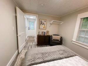 a bedroom with a bed and a desk and a window at Cheerful 1 Bedroom Cottage Close to Everything 5 in Edgecomb
