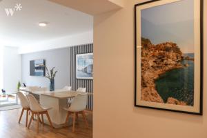 a dining room with a table and a picture on the wall at Classy 2BR in Miraflores in Lima