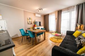 a living room with a couch and a table at Apartament Miodowa 42 z miejscem parkingowym in Krakow