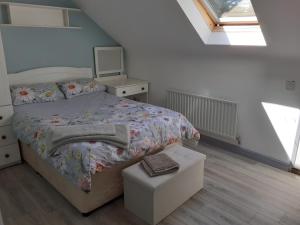 a small bedroom with a bed and a drawer at Foreen Lodge, Achill Island in Achill
