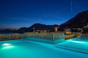 a large swimming pool with a blue sky at Tramonto d'Oro in Praiano