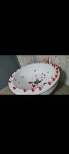a white bath tub covered in confetti at Apartmani 2 SS in Ohrid