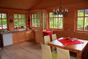 a kitchen with a table and chairs in a cabin at Vila Krivec in Bled