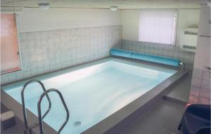 a pool of water in a bathroom with at Stunning Home In Ringkøbing With Sauna in Klegod +27 photos