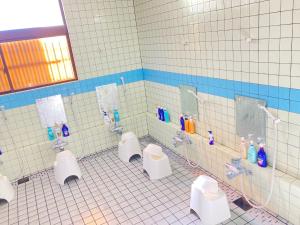 a bathroom with four urinals in a tiled room at Fuyosankyoenka - Vacation STAY 98171v in Fujikawaguchiko