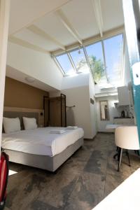 a bedroom with a large bed and a window at Plantage Garden Apartments in Amsterdam