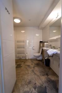 a bathroom with a toilet and a sink at Plantage Garden Apartments in Amsterdam