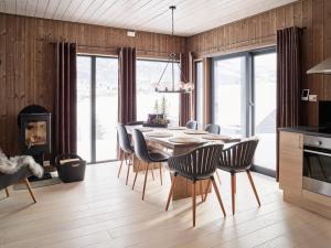 a kitchen and dining room with a table and chairs at Fjellsætra Alpegrend in Sykkylven