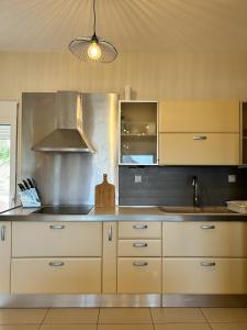 a kitchen with white cabinets and a sink at Villa Despina 2 Plakias Private Villa, Private Swimming Pool Garden, Panoramic Sunset in Asómatoi