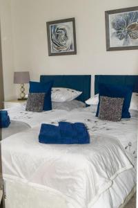 two beds in a room with blue and white at Beval Cottage in Abergavenny