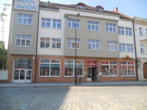 a building with a street light in front of it at Hotel Avion in Prostějov