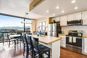 a kitchen and dining room with a table and chairs at Sand & Sea: Coastal Cove (518) in Seaside